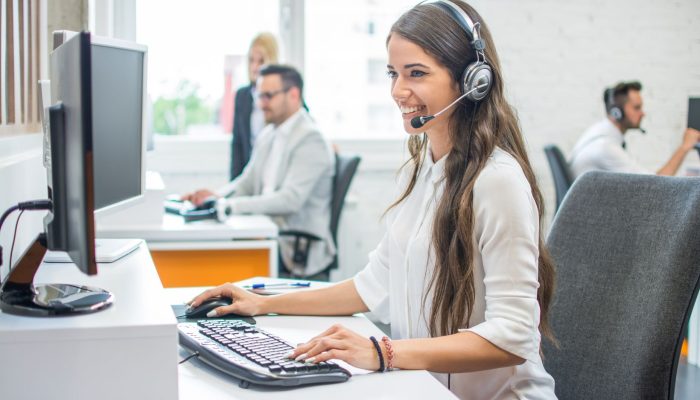 Young,Smiling,Operator,Woman,Agent,With,Headsets,Working,In,Call